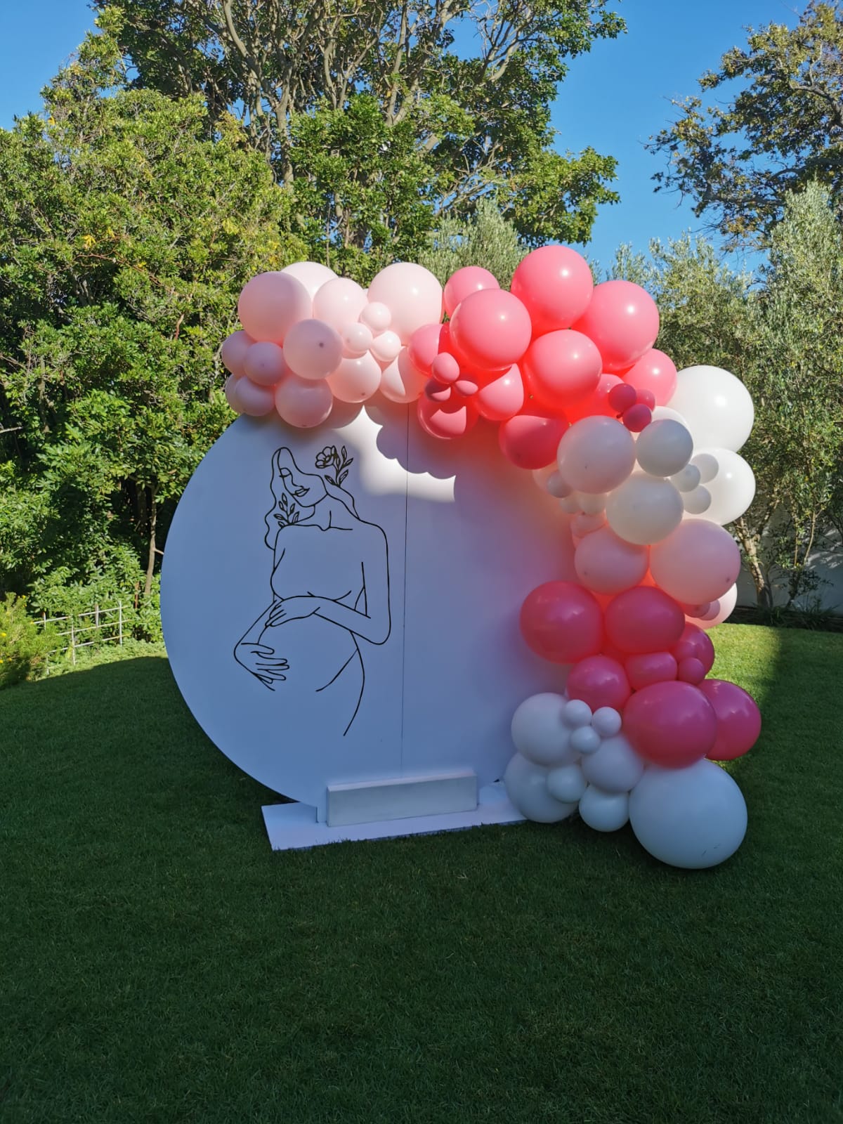 Personalised white round board with a lush pink and white balloon garland