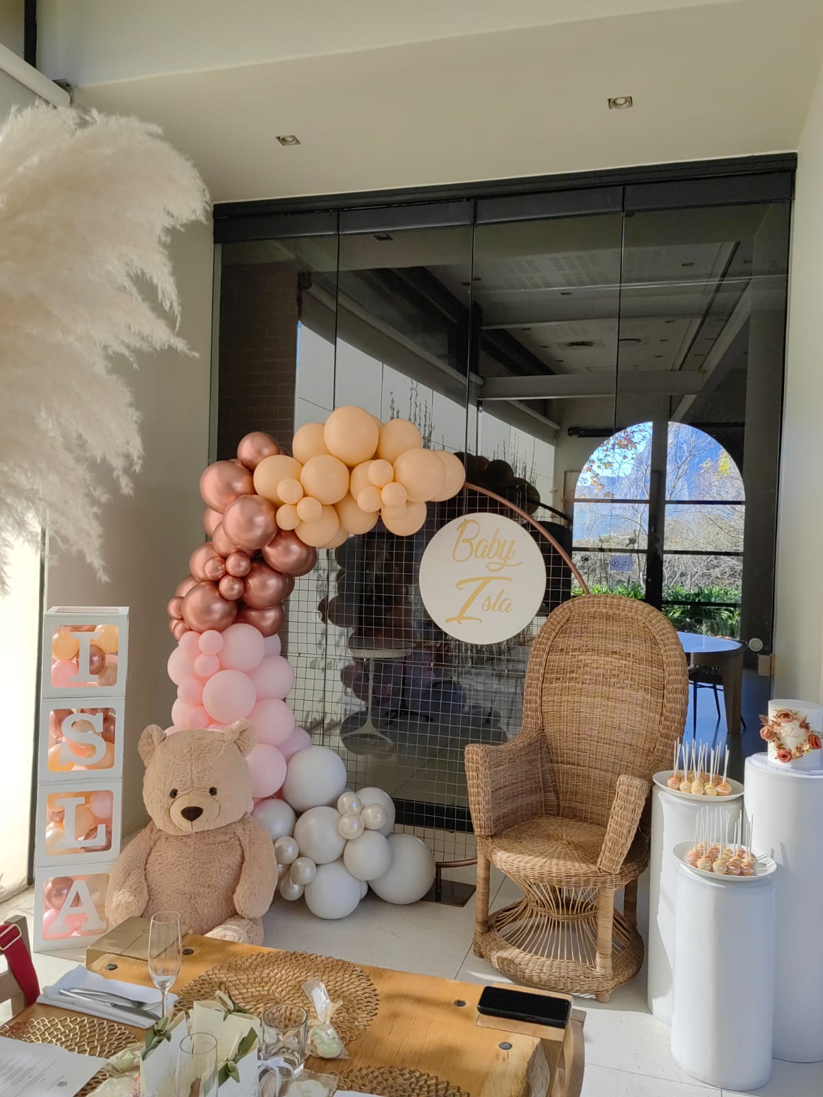 Personalised small white board with our mesh round circle complimented by a beautiful garland, teddy bear, baby boxes and our peacock chair